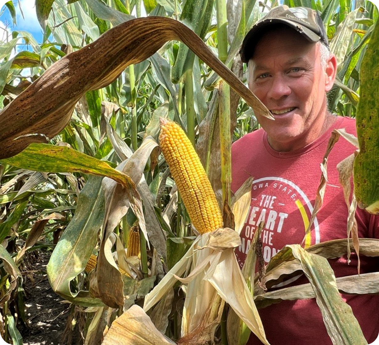 Trent Clapper Farmer in Between Corn Stalks in Iowa